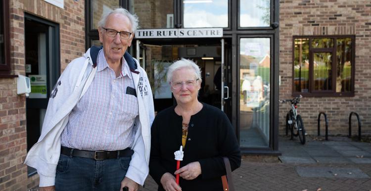 Man and a woman standing side by side outside a medical centre
