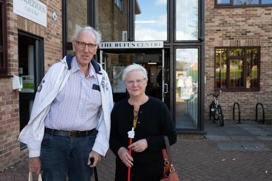 Man and a woman standing side by side outside a medical centre