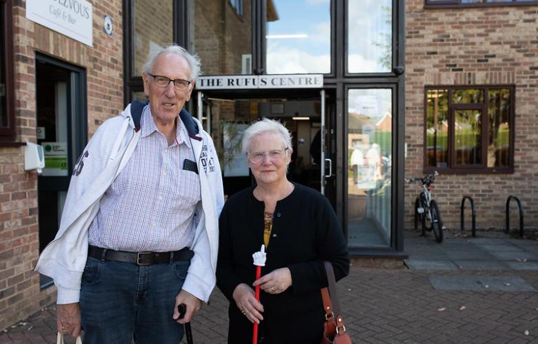 Man and a woman standing side by side outside a medical centre